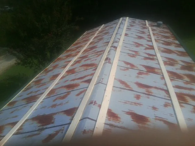 Rusted metal roof panels with new wood purlins before replacement — Storm Damage Roof Repair in Weiser by Roofing Brothers