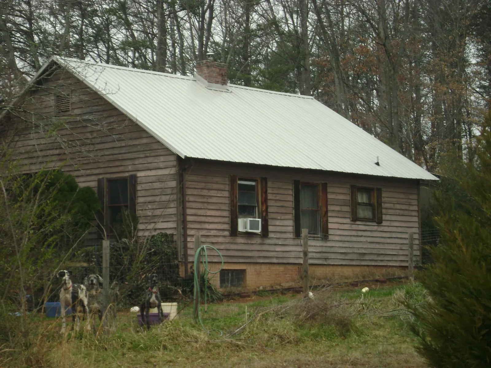 White metal roof on an old wood sided farmhouse, from a Metal Roof Installation job in Weiser